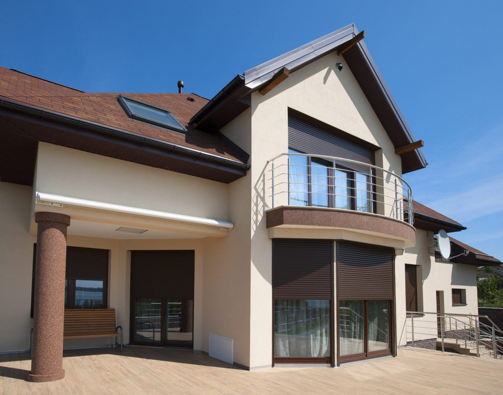 hurricane shutters on the outside of a large home